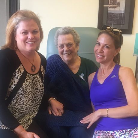 volunteers provides companionship to patient in to the chemo lounge