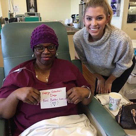 image of a Chemo Companions volunteer with a patient offering encouragement and some gifts