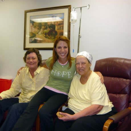 volunteer provides companionship to patient in to the chemo lounge